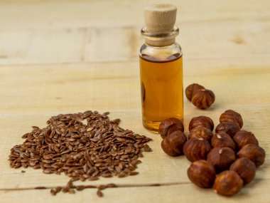 Şişede yağ ve ahşap bir arka planda fındık.