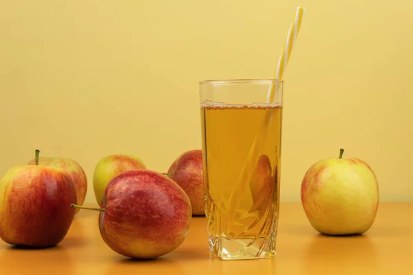 Apples and apple juice in a glass background for text. Healthy apple juice on a background of apples