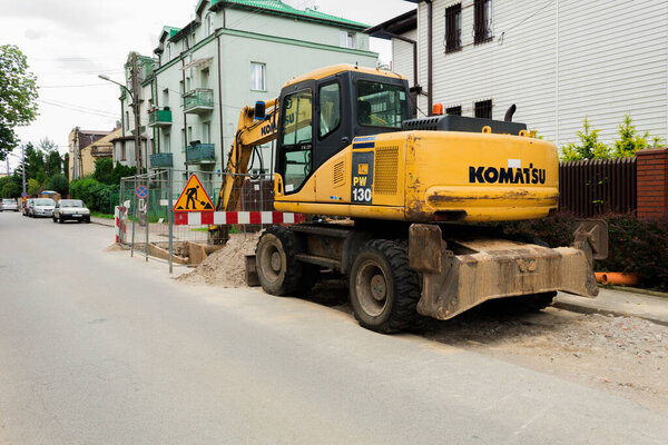 Warsaw, Poland - June 16, 2020: Wheel excavator on a city street. End of work, excavator bucket in the pit