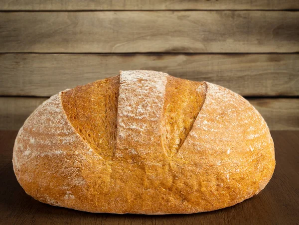 Ahşap zeminde taze pişmiş ekmek. Ev yapımı Kaba Kahverengi Ekmek