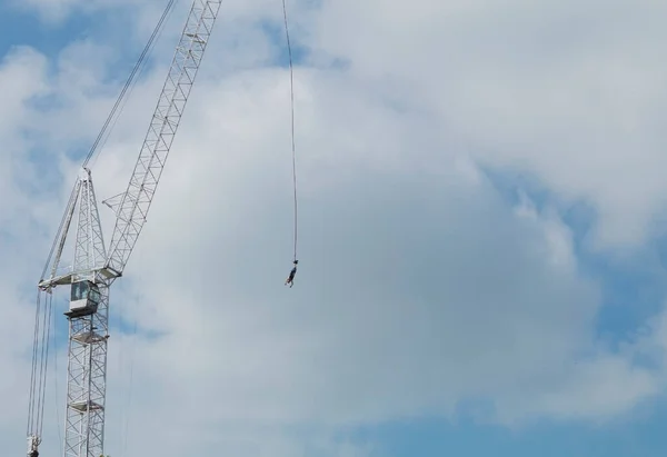 Sports jump from a height of a tower crane. Maximum basket lift and jump