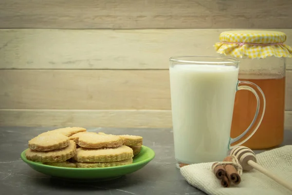 Cookies with milk and honey as a background for text
