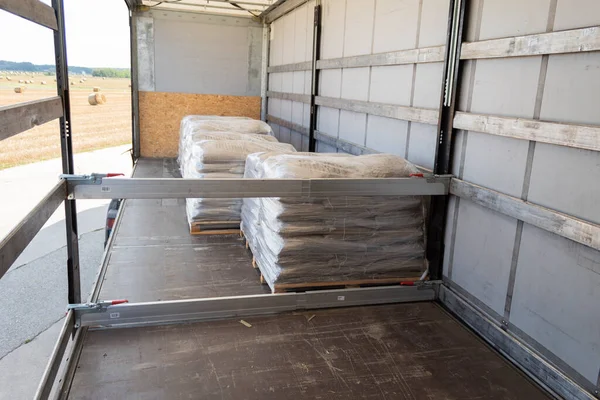 Loading goods onto a truck trailer. Unloading a trailer of pallets with goods