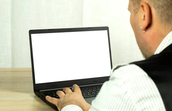 A man looks into a computer monitor. Laptop monitor for inserting images or text. Learning and working online