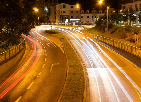 Road markings and right turn in the city at night. Long exposure photo of cars and the road at night