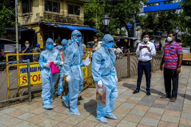 Mumbai, Hindistan / 17 Haziran 2020: Bir Corona virüs tarama kampı sırasında Ghatkopar East 'teki Ramabai Ambedkar Nagar' ın varoşlarındaki sakinlerin sıcaklıklarını kontrol etmek için sağlık görevlileri geldi.