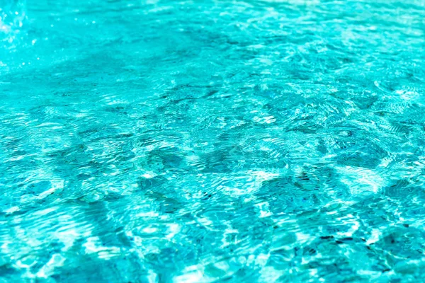 Abstract background of a blue and wavy water surface in a swimming pool or spa jacuzzi