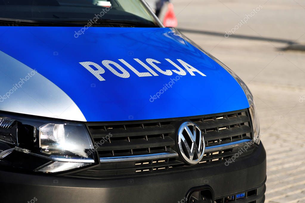 Krakow, Poland - February 16, 2019: Close-up of Policja sign on the polish police car on the street of Krakow during public event.