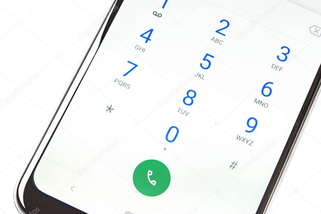 Modern smartphone screen with numbers dialing keypad in close-up on a white background