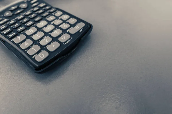 close up Scientific calculator on wooden desk with copy space