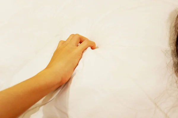 gesture of woman\'s hand is Tense and Creepy when maul pillow While having sex on bed