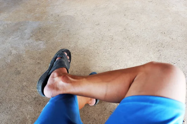 leg of man when sit in relax gesture is outdoor