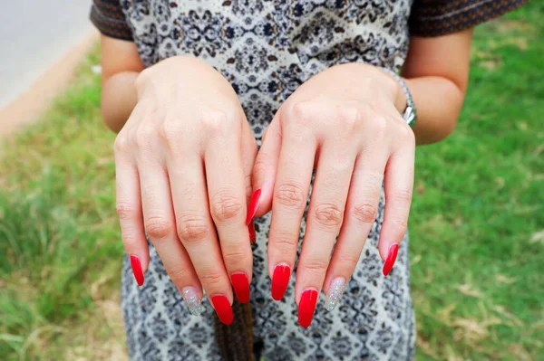 レッドシェードの女性の指のペイントファッション輝くダイヤモンドのいくつかの指で 彼女は屋外です — ストック写真
