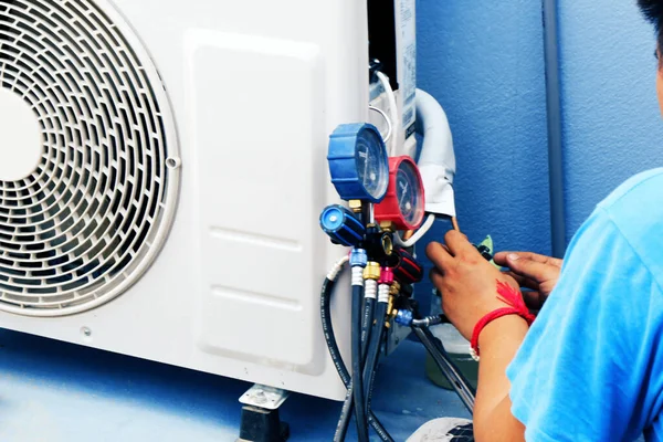 Air Conditioning Technician is Repairing air conditioner ,Because of leakage of air solution at the pipe joint