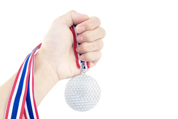 Hand holding medal trophy isolated on white background.
