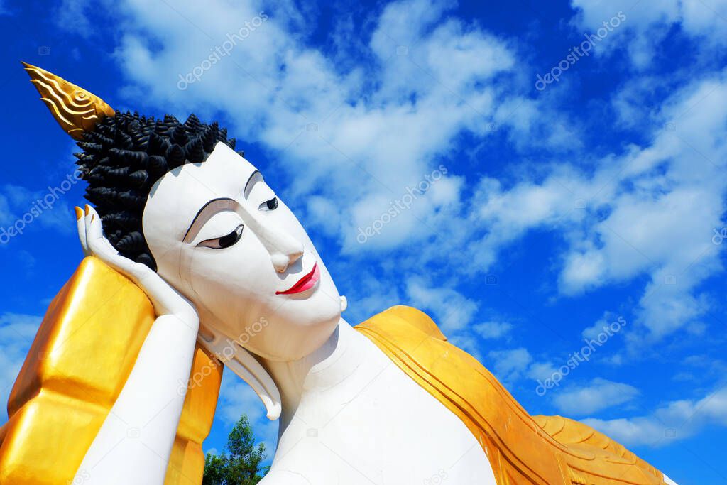View of large Buddha statue in the sleeping posture with sky view at Phan temple,Chiang rai,Thailand.