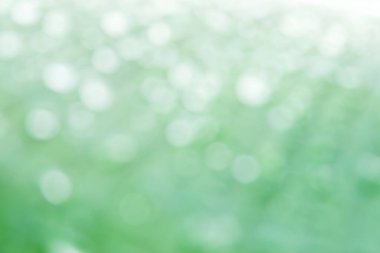 Beyaz daire bokeh bulanık arkaplan muz yaprağı üzerindeki su damlası fotoğrafından soyut arkaplan.