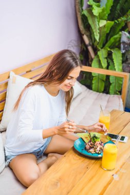 Şık bir kafe, sağlıklı kahvaltı, meyve, taze sıkılmış meyve suyu, kahvaltı güzel bir kadın olan tropikal konumu.