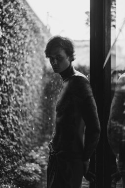 Genç dövmeli adam karşı yağmur poz