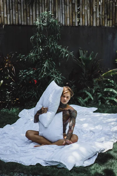 Young Handsome Tattooed Man Morning Bed Tosses Pillows Bed Garden — Stock Photo, Image