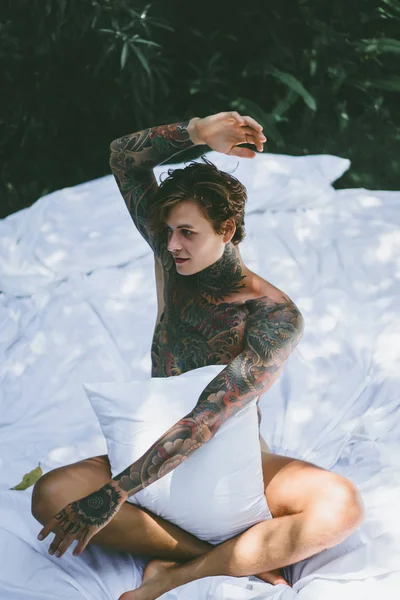 Young Handsome Tattooed Man Morning Bed Tosses Pillows Bed Garden — Stock Photo, Image