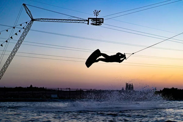 wakeboard. wakeboarding jumping at sunset