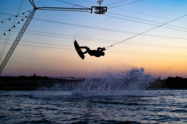 wakeboard. wakeboarding jumping at sunset