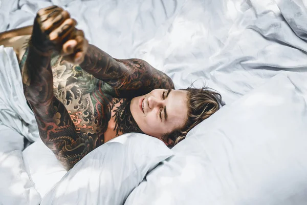 Knappe Jongeman Tatoeages Ontspannen Bed — Stockfoto