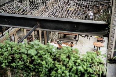 tropikal bir yerde, palmiye ağaçları ve yeşil, güneş gözlüklü bir arka plan üzerinde poz genç çekici adam