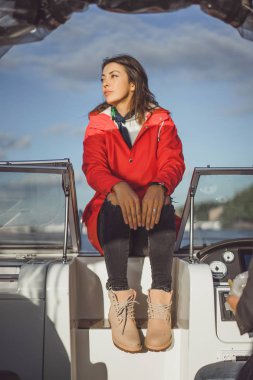 kırmızı bir yağmurluk güzel genç kadın ile özel yat gidiyor. Stockholm, İsveç