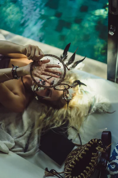 Indian girl at home. Dream catchers. beautiful blonde girl with dream catchers.
