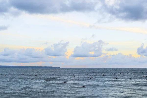 sky and ocean beautiful sunset on the ocean. surfers waiting for a wave.