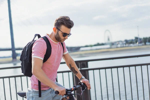 young man riding bicycle on the street