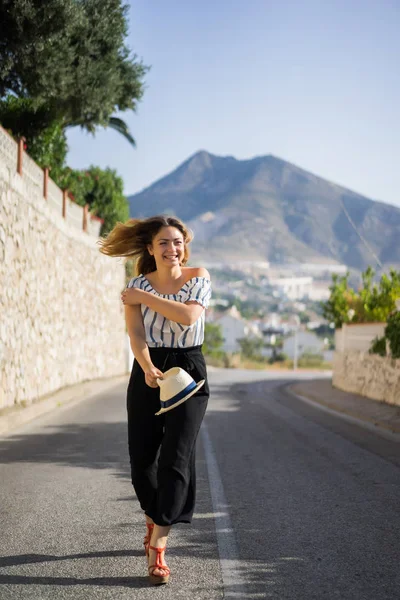 Genç ve güzel bir kadın küçük bir Avrupa kasabasının sokaklarında yürüyor. yaz tatili