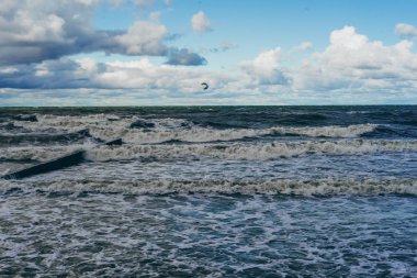 kiting on the cold Baltic Sea clipart