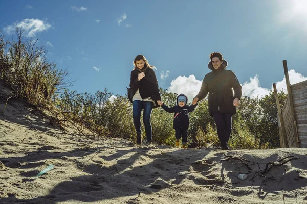 若い家族は子供と小さな子供と寒いバルト海 暖かいジャケット 家族の週末の海岸に週末を費やしています — ストック写真