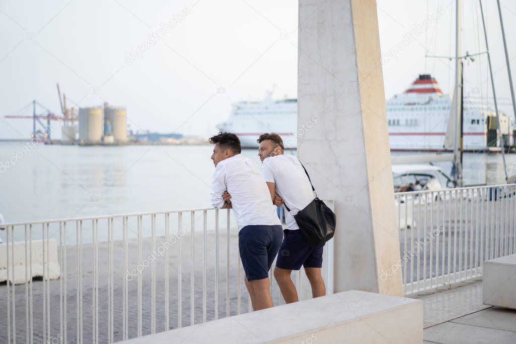 two men of a friend on the city promenade in Malaga