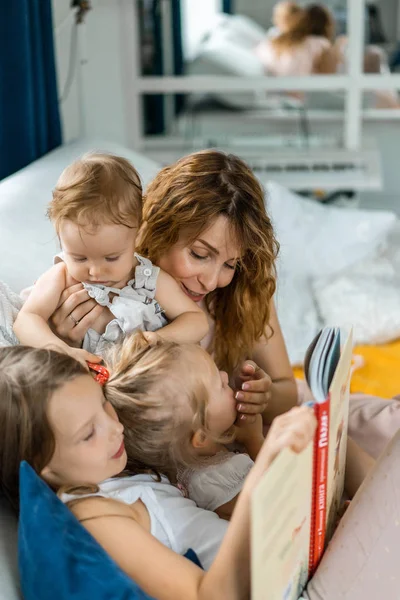 Мати Трьома Дітьми Читає Книжку Домашній Обстановці Ділячись Часом Батьками — стокове фото