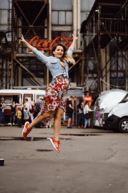 Bir bardak kahve ile uzun saçlı güzel bir genç kadın gülümsüyor ve gülüyor. dış yakın çekim portre