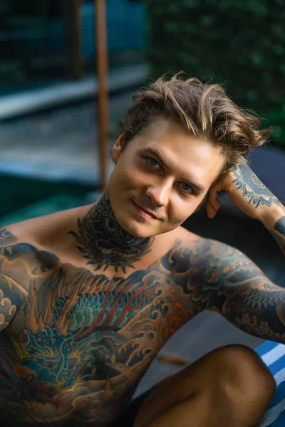 portrait of a handsome man in tattoos