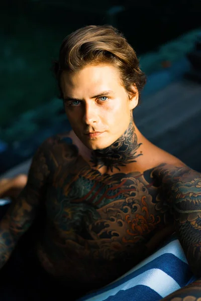 portrait of a handsome man in tattoos