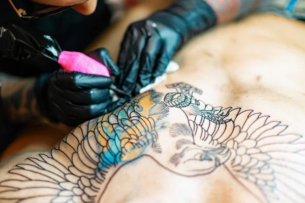 Tattoo salon process. A tattoo girl stuffed a tattoo. the proces
