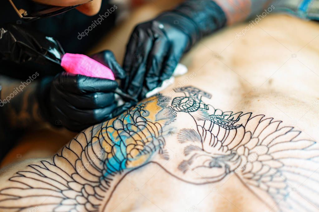 Tattoo salon process. A tattoo girl stuffed a tattoo. the proces