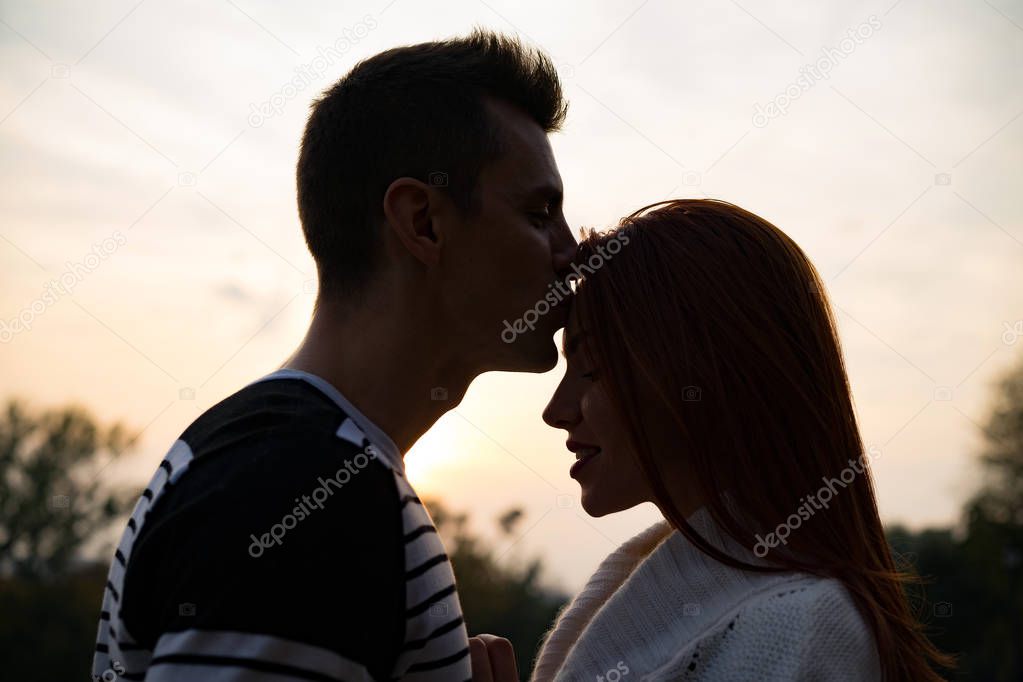 young couple in love. Lovers man and woman in the park in autumn, tenderness, hugs and kisses, happy couple.