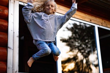 girl jumping and having fun. Happy childhood, games, fun.