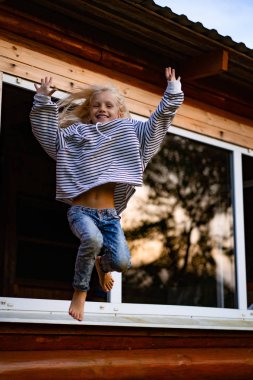girl jumping and having fun. Happy childhood, games, fun.
