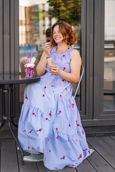 カフェで赤い髪の女性が夏のカクテルを飲んで幸せ笑い笑顔 — ストック写真