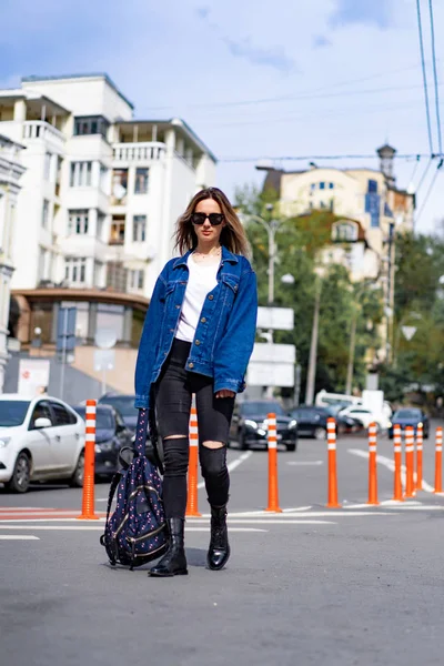 Genç, güzel bir kadın Avrupa 'da şehirde dolaşıyor, sokak fotoğrafı, şehir merkezinde poz veren bir kadın.