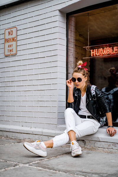 Young beautiful woman walks around the city in Europe, street photo, female posing in the city center