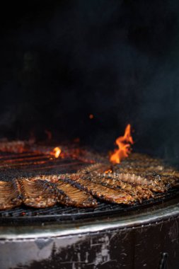 rib, rib restaurant, the process of preparing pork ribs on an open fire clipart